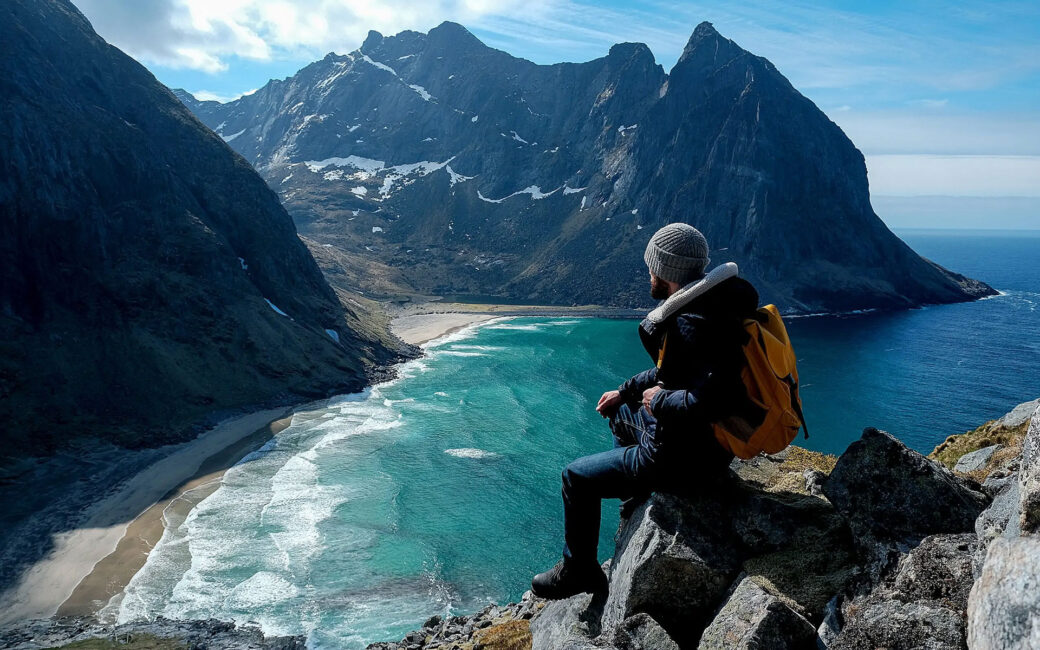 Man sitting atop a mountain